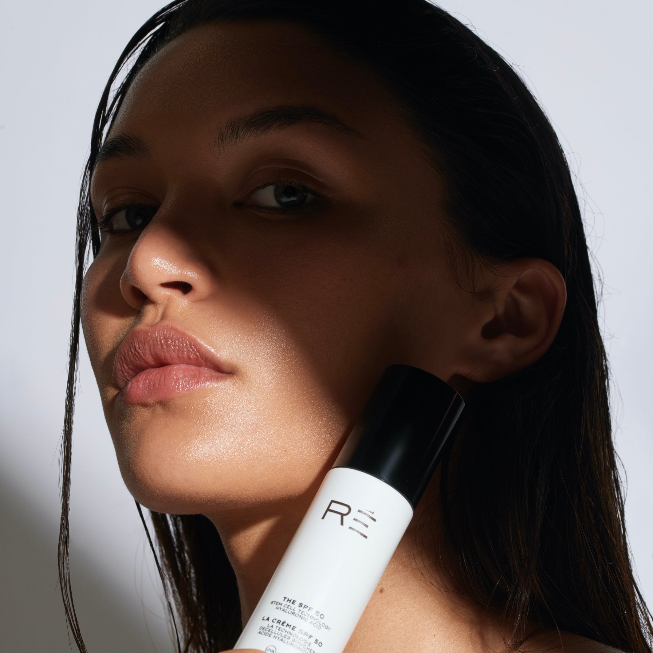 model holding sunscreen